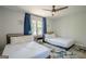Airy bedroom with two twin beds, ceiling fan, and large windows at 3833 Bakers Ferry Sw Rd, Atlanta, GA 30331