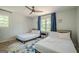 Bright bedroom with two twin beds, ceiling fan, and modern decor at 3833 Bakers Ferry Sw Rd, Atlanta, GA 30331