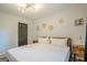 Bright bedroom with white bedding, stylish light fixture, and modern wall decor at 3833 Bakers Ferry Sw Rd, Atlanta, GA 30331