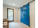 Versatile bonus room with a stylish blue barn door leading to the backyard at 3833 Bakers Ferry Sw Rd, Atlanta, GA 30331