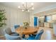 Stylish dining area with a round wood table that seamlessly connects to a bright and updated kitchen at 3833 Bakers Ferry Sw Rd, Atlanta, GA 30331
