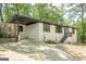 Charming single-story home featuring a blue front door, painted brick, and a carport at 3833 Bakers Ferry Sw Rd, Atlanta, GA 30331