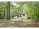 Charming single-story home featuring a blue front door, painted brick, and mature trees at 3833 Bakers Ferry Sw Rd, Atlanta, GA 30331