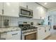 Updated kitchen with stainless steel appliances, granite countertops, and stylish black hardware at 3833 Bakers Ferry Sw Rd, Atlanta, GA 30331