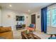 Inviting living room with stylish furniture, wood floors, a dark door and large window at 3833 Bakers Ferry Sw Rd, Atlanta, GA 30331