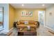 Inviting living room with stylish furniture, wood floors, and a mustard accent wall at 3833 Bakers Ferry Sw Rd, Atlanta, GA 30331