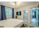 Bright and airy main bedroom showcasing a modern light fixture and ensuite bathroom at 3833 Bakers Ferry Sw Rd, Atlanta, GA 30331