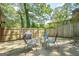 Concrete patio with outdoor seating, grill, and a wood fence surround at 3833 Bakers Ferry Sw Rd, Atlanta, GA 30331