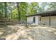 Outdoor patio featuring seating, surrounded by trees, and a fenced-in yard at 3833 Bakers Ferry Sw Rd, Atlanta, GA 30331