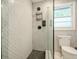 Renovated shower with herringbone tile, glass door, and sleek fixtures at 3833 Bakers Ferry Sw Rd, Atlanta, GA 30331