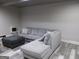 Finished basement featuring a sectional sofa and ottoman, perfect for relaxing at 216 Lake Tanisha Dr, Dallas, GA 30157
