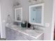 Modern bathroom with dual sinks, marble countertops, gray cabinets, and framed mirrors for a clean, sophisticated look at 216 Lake Tanisha Dr, Dallas, GA 30157