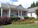Charming brick home featuring a welcoming front porch and beautifully landscaped front yard with colorful flowers at 216 Lake Tanisha Dr, Dallas, GA 30157