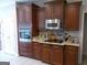 Well-equipped kitchen with wood cabinets, stainless steel appliances, granite counters, and a functional layout at 216 Lake Tanisha Dr, Dallas, GA 30157