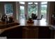 Open kitchen design with a granite countertop island, stainless steel appliances, and a view of the outdoor deck at 216 Lake Tanisha Dr, Dallas, GA 30157