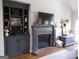 Cozy living room with a charming fireplace, built-in shelving, and a neutral color scheme for a relaxed atmosphere at 216 Lake Tanisha Dr, Dallas, GA 30157