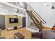 Modern living room boasts a minimalist design with a floating staircase and entertainment center at 692 Kirkwood Se Ave # A, Atlanta, GA 30316