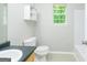 Bathroom with tile flooring, neutral walls, standard toilet and vanity, and natural light at 420 Callaway Pt, Mcdonough, GA 30252