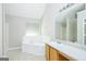 Well-lit bathroom with soaking tub, vanity, and neutral wall and flooring at 420 Callaway Pt, Mcdonough, GA 30252