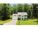 Charming two-story home with a well-manicured lawn, attached garage, and mature trees at 420 Callaway Pt, Mcdonough, GA 30252