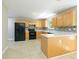 Spacious kitchen with wooden cabinets, modern appliances, and tiled floors and backsplash at 420 Callaway Pt, Mcdonough, GA 30252