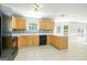 Well-lit kitchen features neutral cabinetry, stylish backsplash, modern appliances, and tile flooring at 420 Callaway Pt, Mcdonough, GA 30252