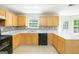 Functional kitchen with wood cabinets, stainless steel sink, and neutral countertops and backsplash at 420 Callaway Pt, Mcdonough, GA 30252