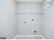 Laundry room with tile floor and white wire shelving for storage at 420 Callaway Pt, Mcdonough, GA 30252