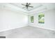 Spacious main bedroom with neutral walls, tray ceiling, and plush carpet flooring at 420 Callaway Pt, Mcdonough, GA 30252