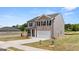 Two-story home with brick and siding, two-car garage, and landscaping providing curb appeal at 612 Whitman Ln, Stockbridge, GA 30281