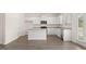 Modern kitchen featuring white cabinets, granite counters, stainless steel appliances, and center island at 612 Whitman Ln, Stockbridge, GA 30281