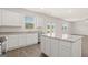 Open kitchen with a center island, granite counters, white cabinets, and stainless steel appliances at 612 Whitman Ln, Stockbridge, GA 30281