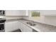 Bright kitchen with stainless steel appliances, granite counters, and a double stainless steel sink at 612 Whitman Ln, Stockbridge, GA 30281