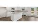 Modern kitchen with white cabinets, granite countertops, stainless steel appliances, and an island at 612 Whitman Ln, Stockbridge, GA 30281