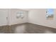 Bright, empty living room with hardwood floors, neutral walls, and natural light streaming through the windows at 612 Whitman Ln, Stockbridge, GA 30281