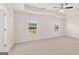 Main bedroom with a ceiling fan, carpet flooring, and lots of natural light from the windows at 612 Whitman Ln, Stockbridge, GA 30281