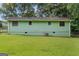 Back of the home showing a lush green lawn and an air conditioning unit at 107 Club Dr, Locust Grove, GA 30248