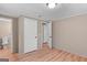 Cozy bedroom with wood-look floors, neutral walls, and multiple closets for storage at 107 Club Dr, Locust Grove, GA 30248