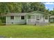 Charming one-story home with a welcoming front porch and well-maintained lawn at 107 Club Dr, Locust Grove, GA 30248