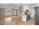 Open-concept living space with wood-look flooring, neutral walls, and great natural light at 107 Club Dr, Locust Grove, GA 30248