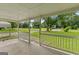Covered front porch with white railing offers a relaxing outdoor space with views of the landscaped yard at 107 Club Dr, Locust Grove, GA 30248