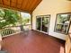Inviting covered back porch with sliding glass door access, perfect for outdoor lounging at 5445 Maltdie, Sugar Hill, GA 30518