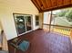 Cozy back porch with wood floors, a relaxing chair, and sliding glass door access to the home at 5445 Maltdie, Sugar Hill, GA 30518