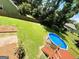 Landscaped backyard featuring an above-ground pool with a deck, surrounded by green grass and a wooden fence at 5445 Maltdie, Sugar Hill, GA 30518