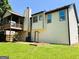 Home's backyard features a deck, covered porch, spacious yard and back entrance at 5445 Maltdie, Sugar Hill, GA 30518