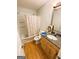 Bathroom boasts a vanity with granite countertop, tub/shower combo, and vinyl flooring at 5445 Maltdie, Sugar Hill, GA 30518
