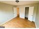 Bedroom with two open doors, one to a closet and another to the hallway, and laminate floors at 5445 Maltdie, Sugar Hill, GA 30518