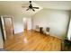 Spacious bedroom with two chairs, vaulted ceiling, and hardwood floors at 5445 Maltdie, Sugar Hill, GA 30518