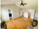 Bedroom featuring hardwood floors, a ceiling fan, and access to the bathroom and closet at 5445 Maltdie, Sugar Hill, GA 30518