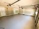 Spacious garage with painted floor, shelves, and access doors at 5445 Maltdie, Sugar Hill, GA 30518